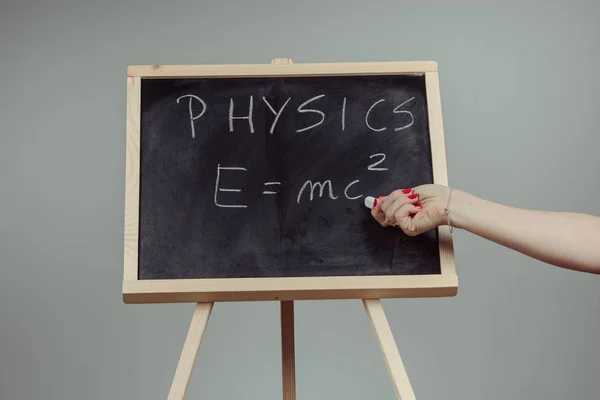 Physics word and formula Emc2 on chalkboard — Stock Photo, Image