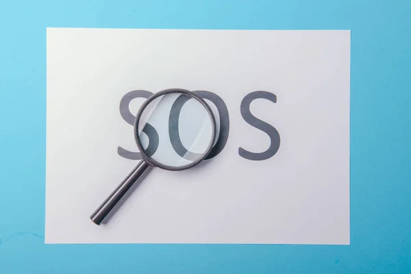 Word SOS written on paper — Stock Photo, Image