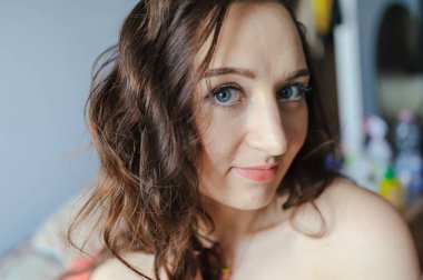 Güzel genç kız evde oturan bir pencere bir gülümseme ile