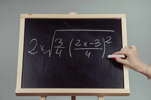 Math exercise on chalkboard