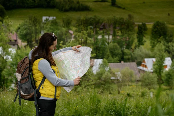 Žena turista turistické stezce drží mapu — Stock fotografie