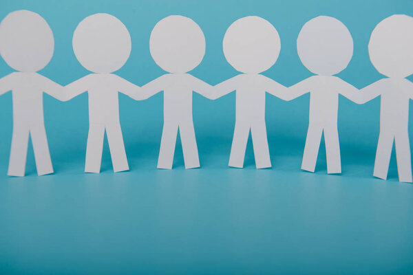 абстрактные бумажные люди, держащиеся за руки
