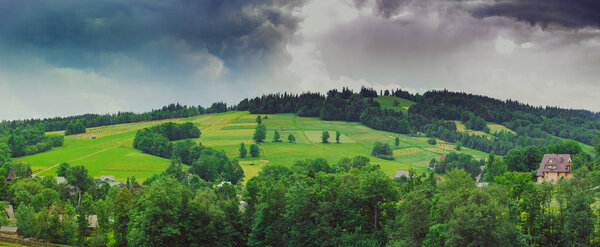 Hills covered with green grass under blue sky Summer landscape background