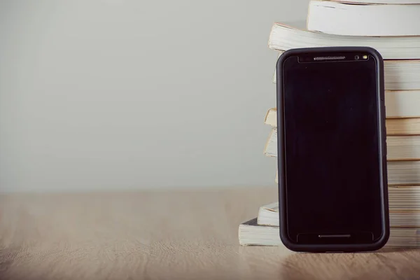 Old vintage books, smartphone — Stock Photo, Image