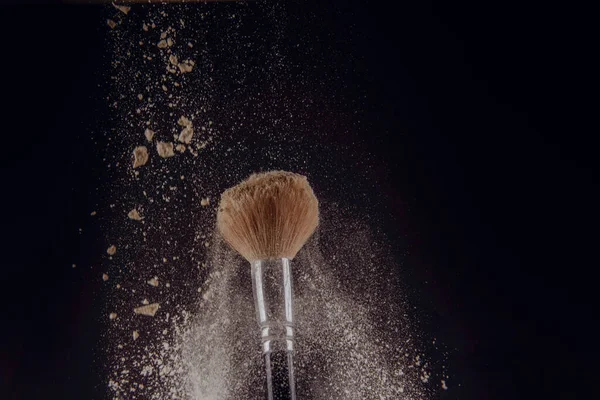 Isolated make-up powder with brush on black background — Stock Photo, Image