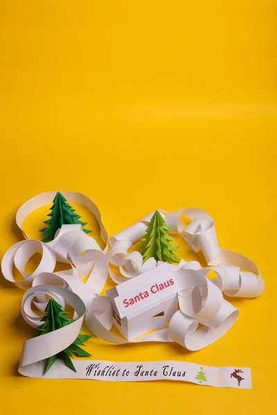 Long twisted expanded letter for Santa Claus. Copy space. yellow background.