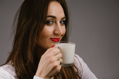 Elinde süt kupa tutan neşeli kız