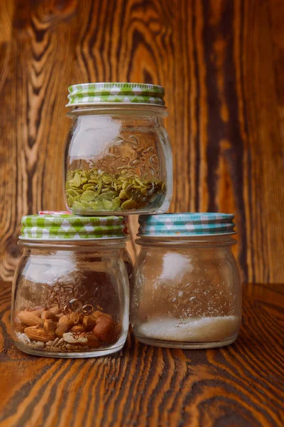 Almonds in a jar on the blue wooden table — Stock Photo, Image