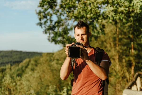 Парень фотографа фотографирует пейзаж — стоковое фото