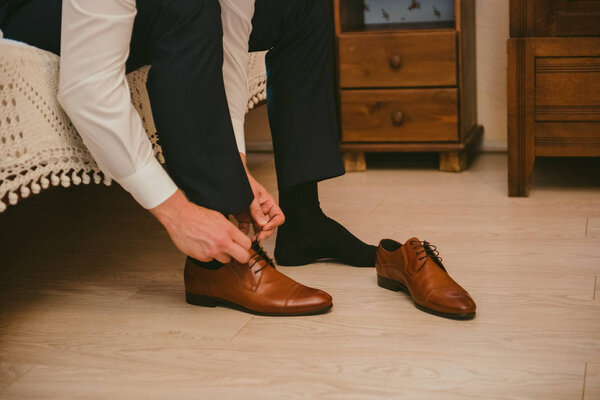Groom black elegant shoes. Wedding detail. Close up.