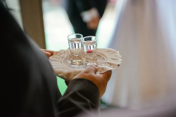 Traditional polish greeting the bride and groom by the parents with bread and salt. Vodka also in glasses — Stock Photo, Image