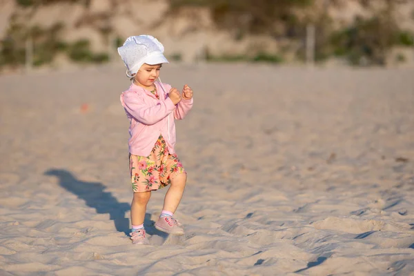 Güneşli bir kumsalda küçük sevimli bir kız. Özgün yaşam biçimi — Stok fotoğraf
