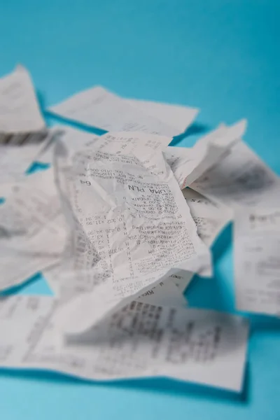 Pile of shopping receipts on blue background — Stock Photo, Image
