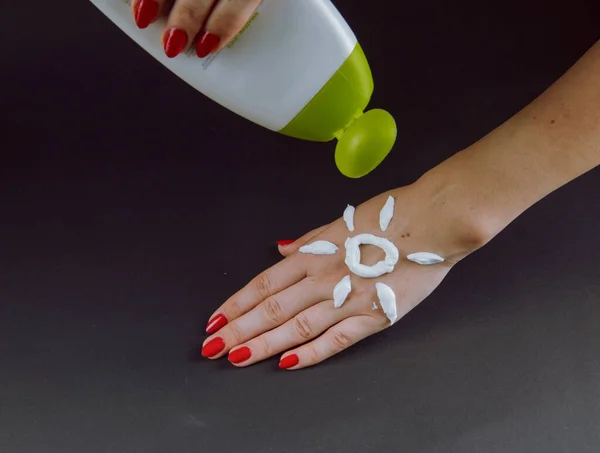 woman applying cream on Hand.