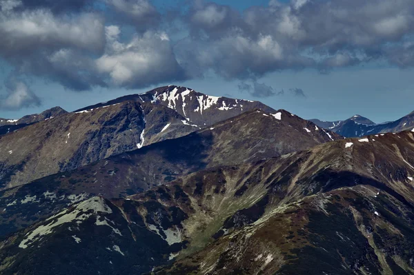 Skalnatými vrcholy a zamračenou oblohou — Stock fotografie