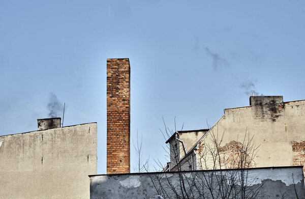 Smoking chimneys old houses and blue sky