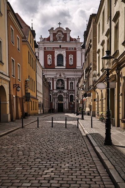 The cobbled street and the facade of the baroque church