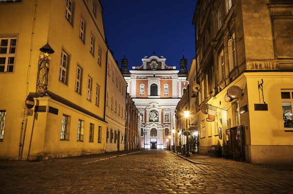Facade of baroque Catholic church at night in Poznan