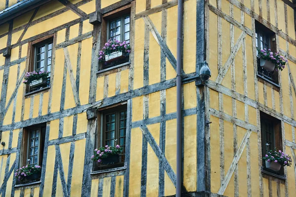 Flowers in the windows of a historic building in the city of Troyes in France