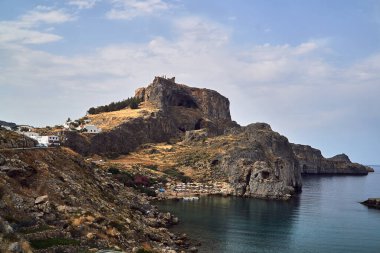 Rocky bay coast with the beach in the city of Lindos