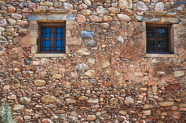 Windows in an old stone wall on the island of Crete in Greece