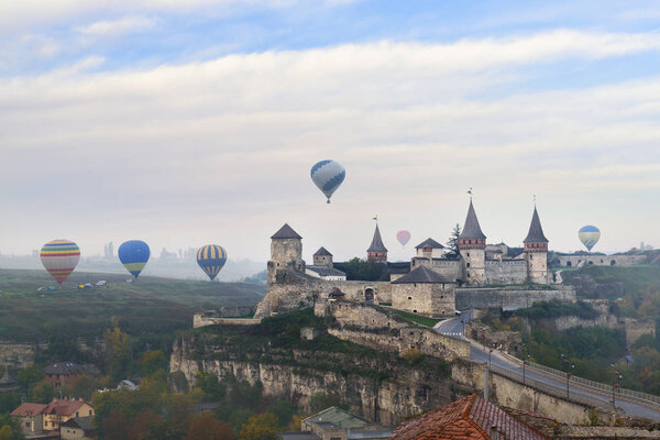 Hot air balloons over ancient castle