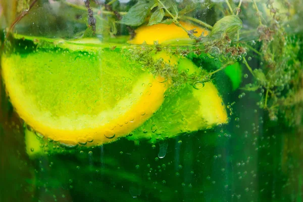 Lemonade background with lemon and herbs — Stock Photo, Image