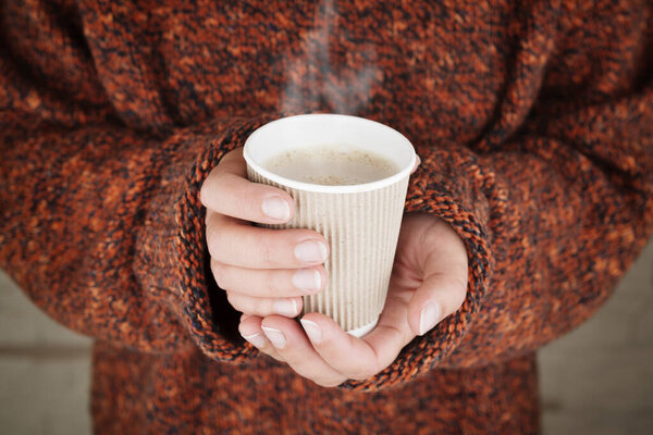 Hot drink in woman hands.