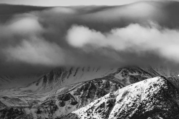 Dramatic art photo of mountain peaks in winter. Black and white