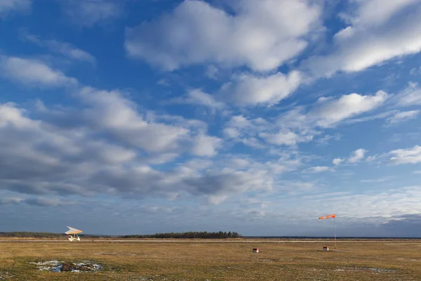 Campo d'aviazione con un piccolo aereo e un calzino a vento . — Foto Stock