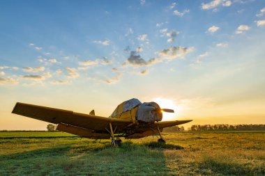 Gün batımında küçük sarı bir uçak. Akşam havaalanında.