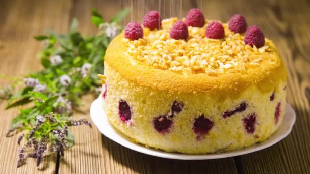 Cake with raspberries sprinkled with powdered sugar — Stock Video