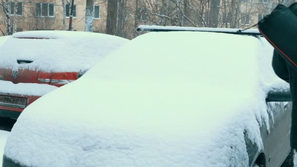 Man Sleaning Car Covered With Snow in Winter Day — Stock Video