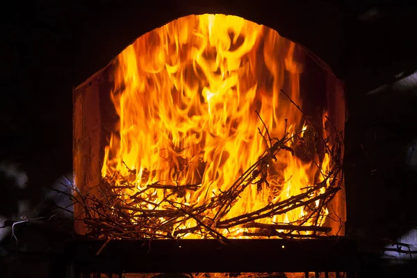 A bright and hot flame in the opening of a stone fireplace. — Stock Photo, Image