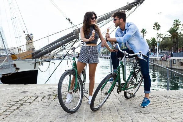 Heureux jeune couple manger de la crème glacée dans la rue . — Photo