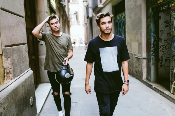 Two young men walking in the street. Stock Image