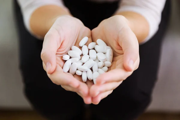 Both hands holding bunch of pills. Overdose or abuse concept. — Stock Photo, Image