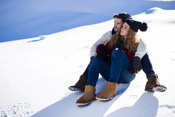 Beautiful young couple in love over winter background. — Stock Photo, Image