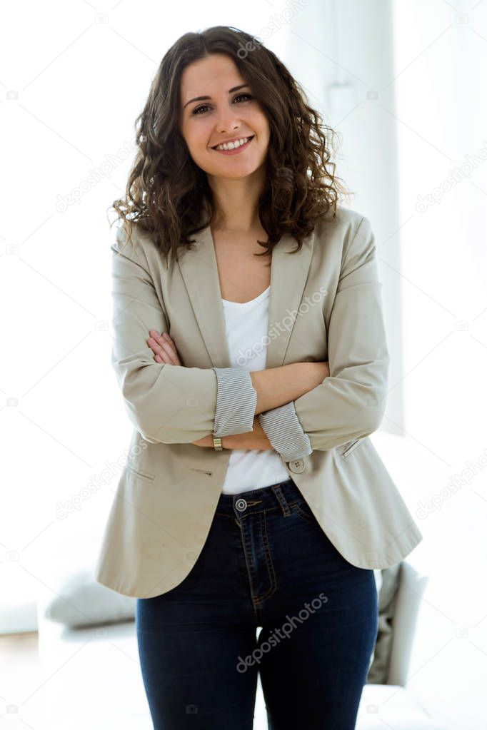 Business young woman looking at camera in the office.