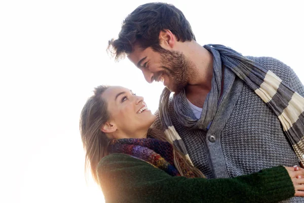 Beautiful young couple in love in a cold winter on the beach. — Stock Photo, Image