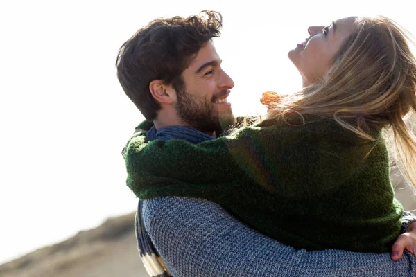 추운 겨울에 하루 해변에서 즐기는 행복 한 젊은 커플. — 스톡 사진