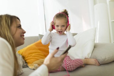 Güzel anne ile kızı evde müzik.
