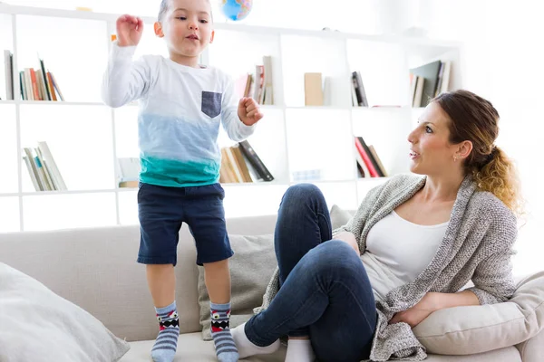 Beautiful young mother and her son having fun at home. — Stock Photo, Image