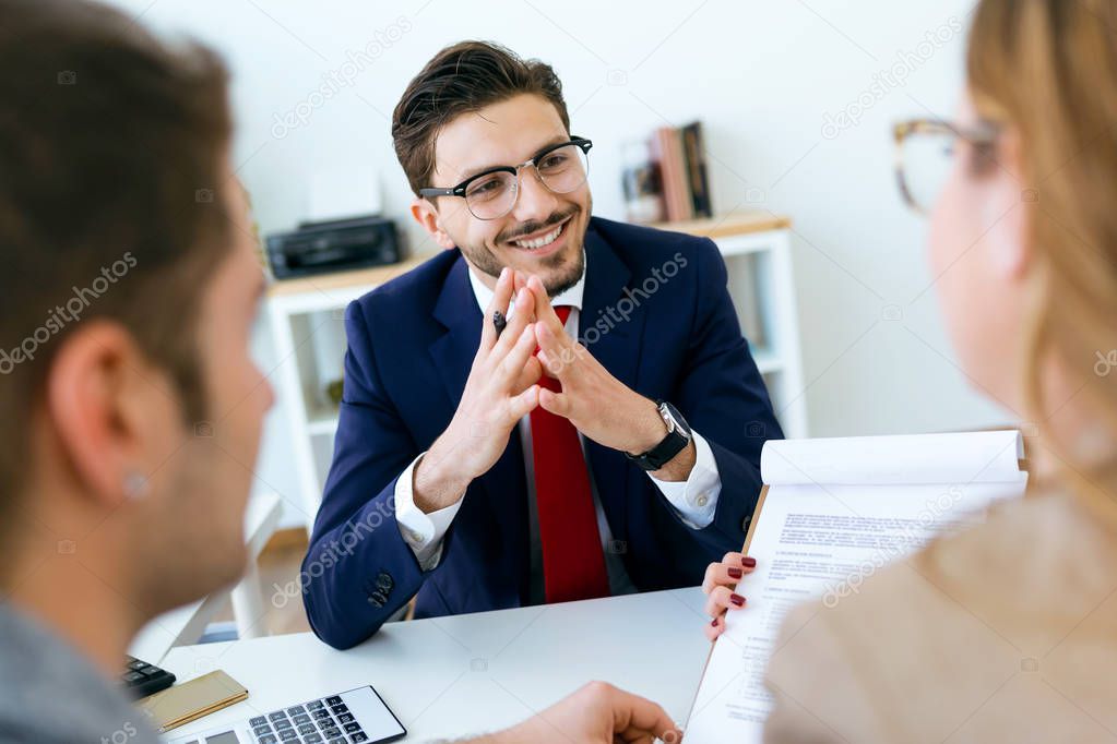 Business man explaining terms of contract to his clients in the 