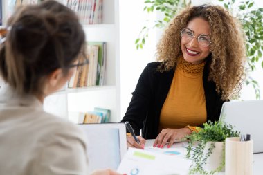 İki işkadını ofisinde dizüstü bilgisayar ile çalışma.