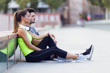 Güzel genç çift sokakta çalıştırdıktan sonra rahatlatıcı.