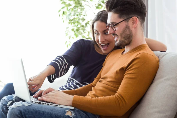 Young man and girl with laptop — Stock Photo, Image