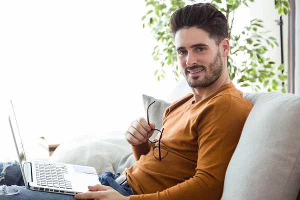 man using his laptop at home.