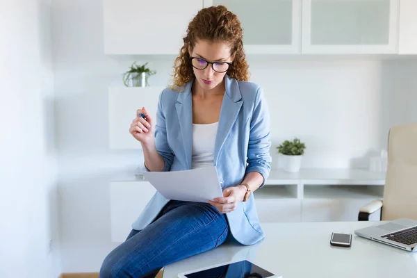 Beautiful business woman reviewing papers in the office. — Stock Photo, Image