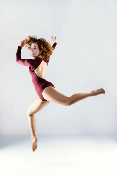 Hermosa joven bailarina profesional bailando sobre fondo blanco —  Fotos de Stock